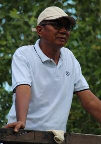 PIcture of a man in a white polo shirt and baseball cap