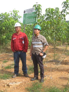 Ishak Yassir and Rehab specialist from in front of experimental site Singlurus